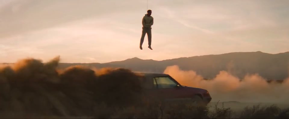 Joji suspended above a drifting car in TEST DRIVE